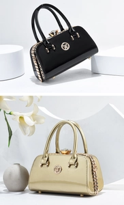 Detail of high-gloss patent leather handbags with crystal clasps and metal hardware