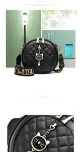 Close-up of black quilted round crossbody bag featuring cat-shaped charm and wide strap