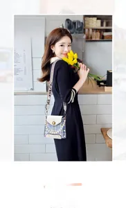 Chic light blue tweed phone bag with pearl handle and jacquard strap in lifestyle shot