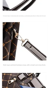Detail of printed handbag featuring golden metal hardware and fine stitching craftsmanship