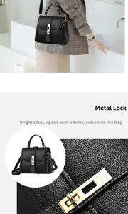 Detail of black lychee leather handbag showing gold twist lock and smooth zipper hardware