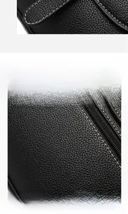 Detail of black lychee grain leather handbag with white stitching and metal zipper