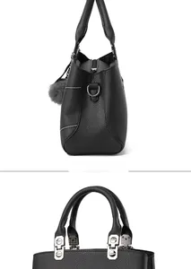 Detailed side view of black litchi pattern handbag with grey fur ball and silver hardware