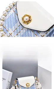 Detail of blue and white tweed bag with golden pearl clasp and beaded pearl strap