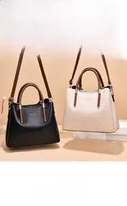 Detailed close-up of premium leather handbags in black and beige with gold hardware