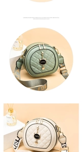 Detail of round quilted crossbody bag with wide logo strap and cat metal charm