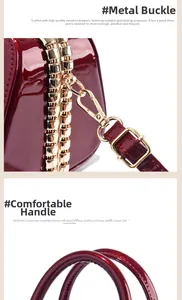 Detailed close-up of gold-plated hardware and stitched handle on burgundy patent bag