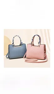 Detail of elegant mother's handbags in gray and pink with stone pattern and silk scarf