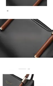 Detail of lychee pattern leather handbag with brown handles and golden metal hardware