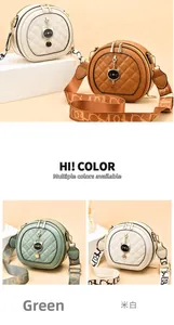 Detail view of quilted round crossbody bag with metal charm and wide fabric shoulder strap