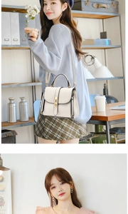 Detail of white lychee leather handbag with gold buckle and adjustable strap