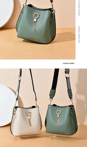 Detail of trendy bucket bag showing cat-ear gold buckle and stylish long tassels