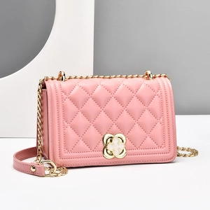 Pink quilted shoulder bag with gold chain strap and floral metal clasp lock