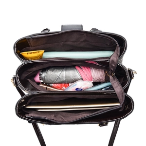 Large capacity printed handbag with three compartments holding a tablet and umbrella