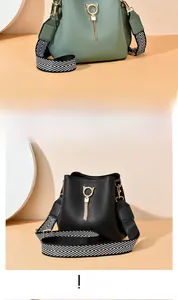 Detail of green and black bucket bags with cat-ear gold rings and tassel hardware