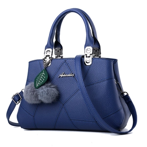 Navy blue faux leather tote bag with geometric stitching and plush charm decoration