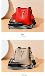 Detailed comparison of red and khaki bucket bags with gold cat hardware and tassel