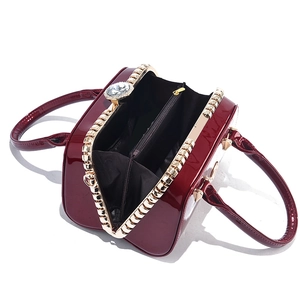 Burgundy patent leather mini bag with gold frame and large crystal lock detail