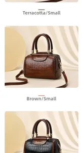 Vertical view of small Boston bags in brown crocodile texture with gold hardware details