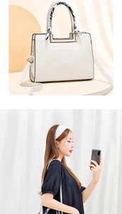 Detail of white crocodile embossed leather bag with decorative silk scarf and metal hardware