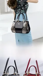 Detail of glossy patent leather handbags with floral embroidery and gold logo hardware