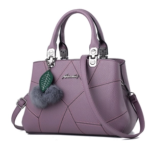Purple faux leather handbag with geometric stitching and removable shoulder strap