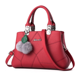 Fashionable red lychee leather handbag with embroidery and grey pompom for women