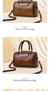 Detail of Boston bag with crocodile texture in khaki and brown with metal buckles