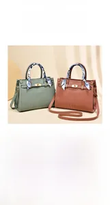 Detail of red and green crocodile texture bags with silk scarf and gold twist lock