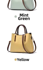 Vertical display of mint green and yellow tote bags with brown handles and golden hardware