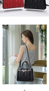 Detail of red and black textured handbags with gold buckles and chic interior lifestyle view