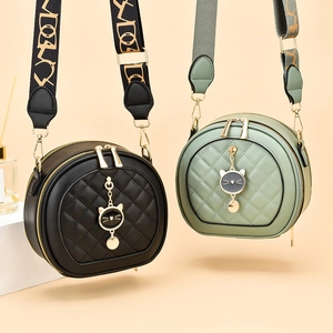 Chic quilted round crossbody bags in black and sage green with wide jacquard straps