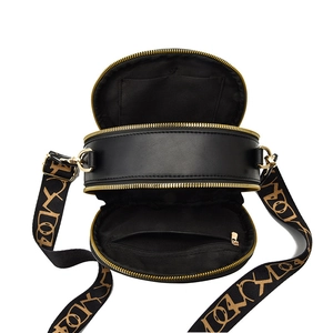 Classic black round quilted leather crossbody bag with dual zippers and woven wide strap