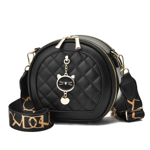 Black round quilted crossbody bag with cat pendant and geometric wide strap