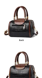 Detail view of the crocodile embossed texture and back zipper pocket on Boston bag