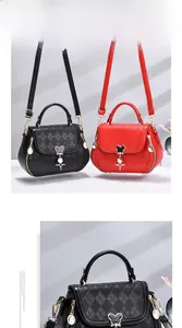 Detailed view of quilted textured crossbody bags in red and black with metal charms