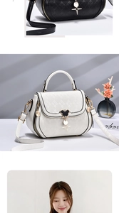 Close-up of quilted pattern details and black mouse-shaped metal clasp on white bag