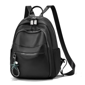 Sac à dos femme noir minimaliste imperméable avec pendentif étoile et multiples poches