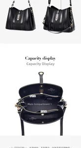 Detailed view showing the large capacity and multiple compartments of the black leather bucket bag