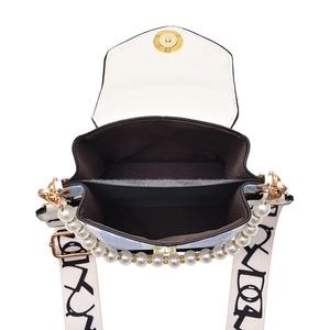 Fashionable rivet crossbody bag with pearl handle and dual-compartment internal design