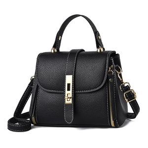 Minimalist black lychee texture handbag with white contrast stitching and gold twist lock