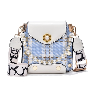 White leather and tweed crossbody bag with pearl floral buckle and rivet details