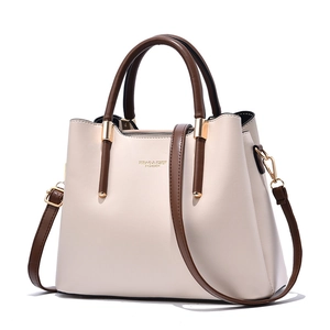 Elegant two-tone beige tote bag with brown handles and gold hardware on white background