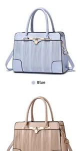 Detail view of wavy texture and metal padlock on light blue and beige handbags