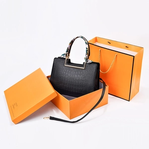Elegant crocodile pattern handbag with scarf-wrapped handle in a luxury gift box