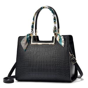 Elegant black crocodile pattern handbag for women with decorative silk scarf on handle