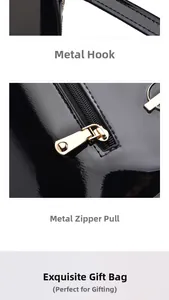 Macro view of glossy black patent leather bag with gold-tone metal hook and zipper detail