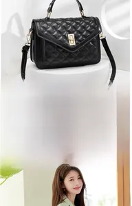 Detail view of quilted black crossbody bag with gold-tone hardware and elegant top handle