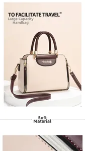 Detail of beige and burgundy contrast handbag with gold logo and soft PU leather texture