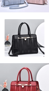 Detail of elegant tote bag with vertical wavy texture and metallic handle ornament